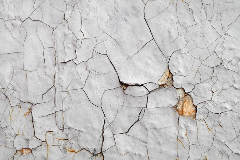 Cracked and peeling paint texture documenting fractures and surface tension