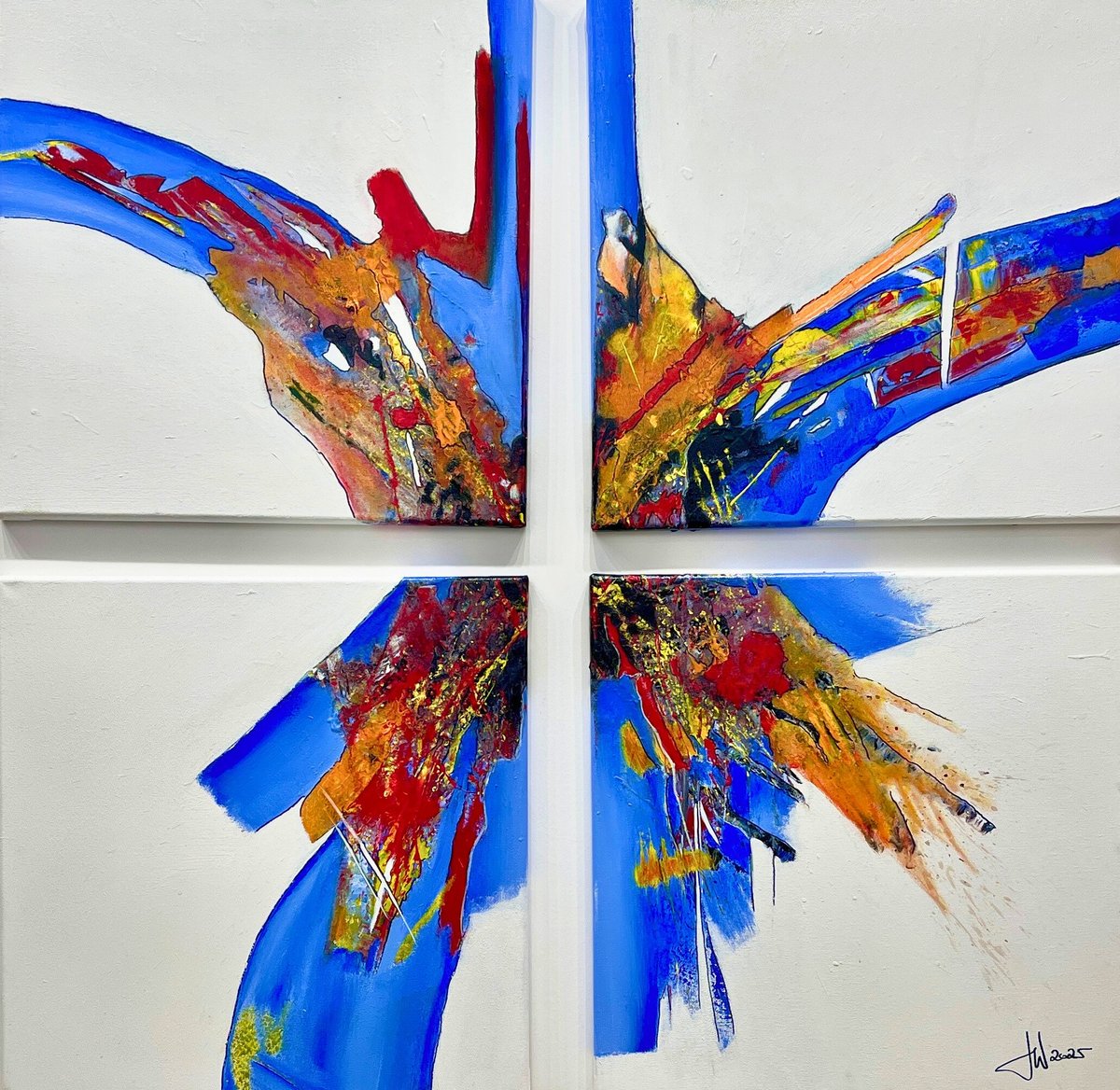 Symmetrical abstract artwork with bright blue ribbons and red-yellow paint splashes arranged in four quadrants forming a cross pattern